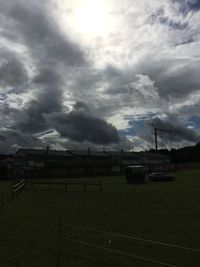 Train on field against storm clouds