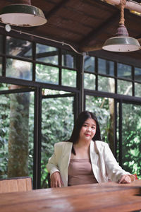 Portrait of woman sitting on table in restaurant