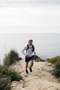 Full length of man running on beach