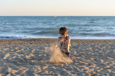 Boy playing on beach