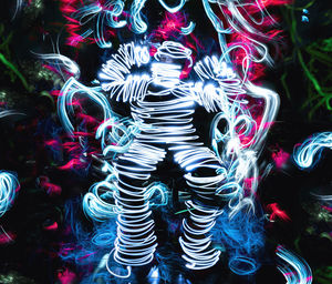 Low section of person standing on multi colored leaves