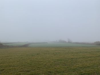 Scenic view of field against sky at foggy weather