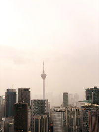 Buildings in city against sky kl tower