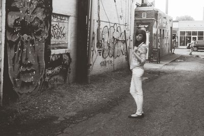 Woman standing against wall