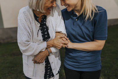 Happy senior woman with female caregiver