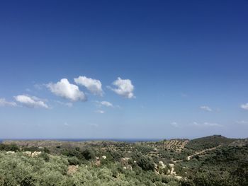 Scenic view of landscape against blue sky