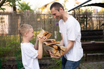 Side view of man holding food at home