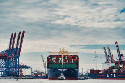 View of commercial dock against cloudy sky