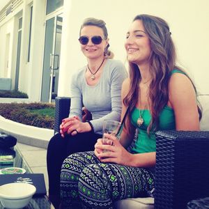 Smiling young woman sitting outdoors