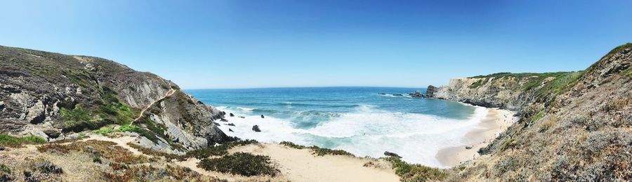 Scenic view of sea against clear blue sky