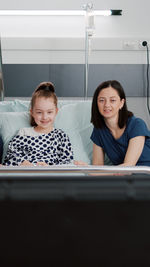 Mother and daughter sitting at hospital