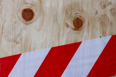 Plywood covered in red and white security tape