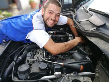 Portrait of man working on motorcycle