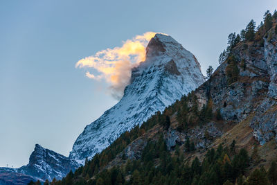 Scenic view of snow covered mountains against sky