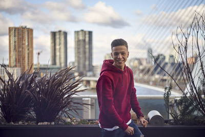 Portrait of smiling man standing against building