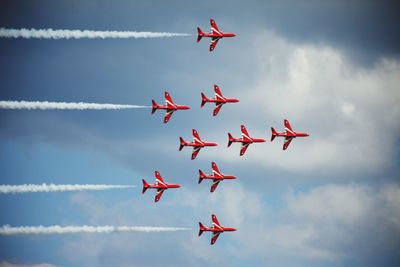 Low angle view of airshow against sky