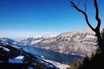 Scenic view of mountains against clear blue sky