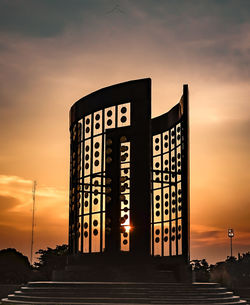 Low angle view of text on road at sunset