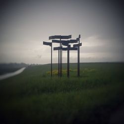 Lifeguard hut on field against sky