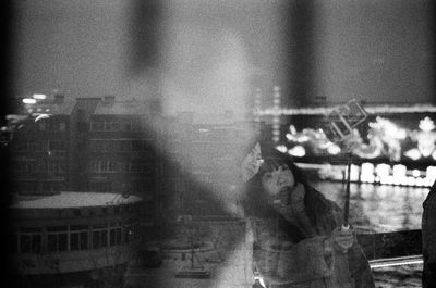 Reflection of people on wet glass window