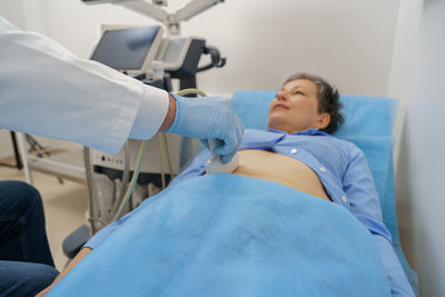 High angle view of doctor examining patient in hospital