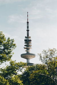 Low angle view of communications tower against sky