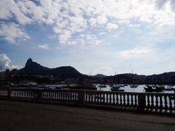 Scenic view of river by city against sky