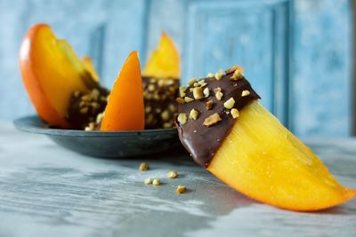 Close-up of orange fruit in plate