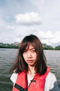 Portrait of woman against lake