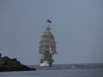 Ship sailing in sea against clear sky