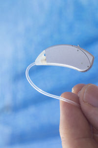 Close-up of person holding hearing aid