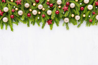 Christmas background. christmas decoration on fir tree branches on light backdrop.  copy space