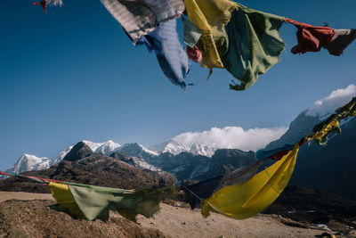 Low angle view of flags against mountains