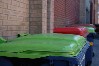 Close-up of green car on brick wall