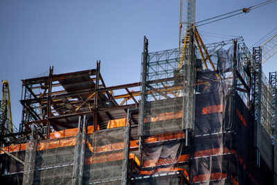 Low angle view of construction site against sky