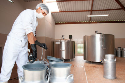 Side view of man preparing food