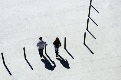 High angle view of people walking on footpath