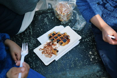 High angle view of people eating waffles