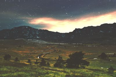 Scenic view of mountains against sky at night