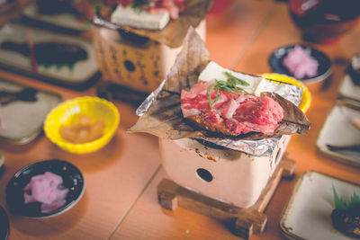 The meat is grilled on an antique stove in a japanese breakfast time.