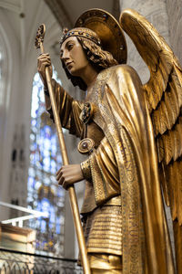 Low angle view of angel statue against temple