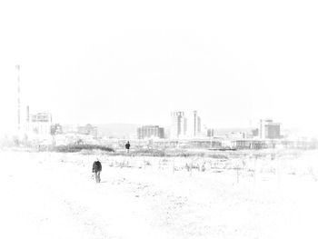 Rear view of man on snow covered land against sky