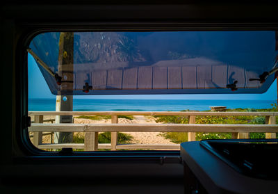 View of swimming pool seen through window