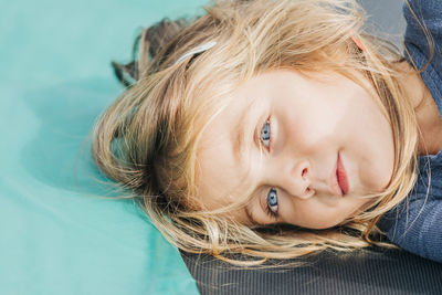 Close-up portrait of a girl lying down on floor