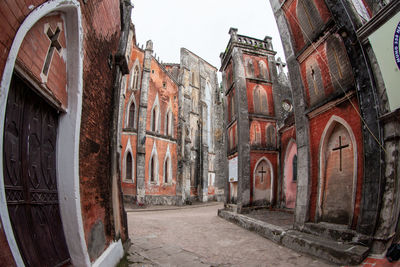 Alley amidst old buildings in city