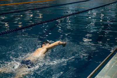 High angle view of man swimming in pool