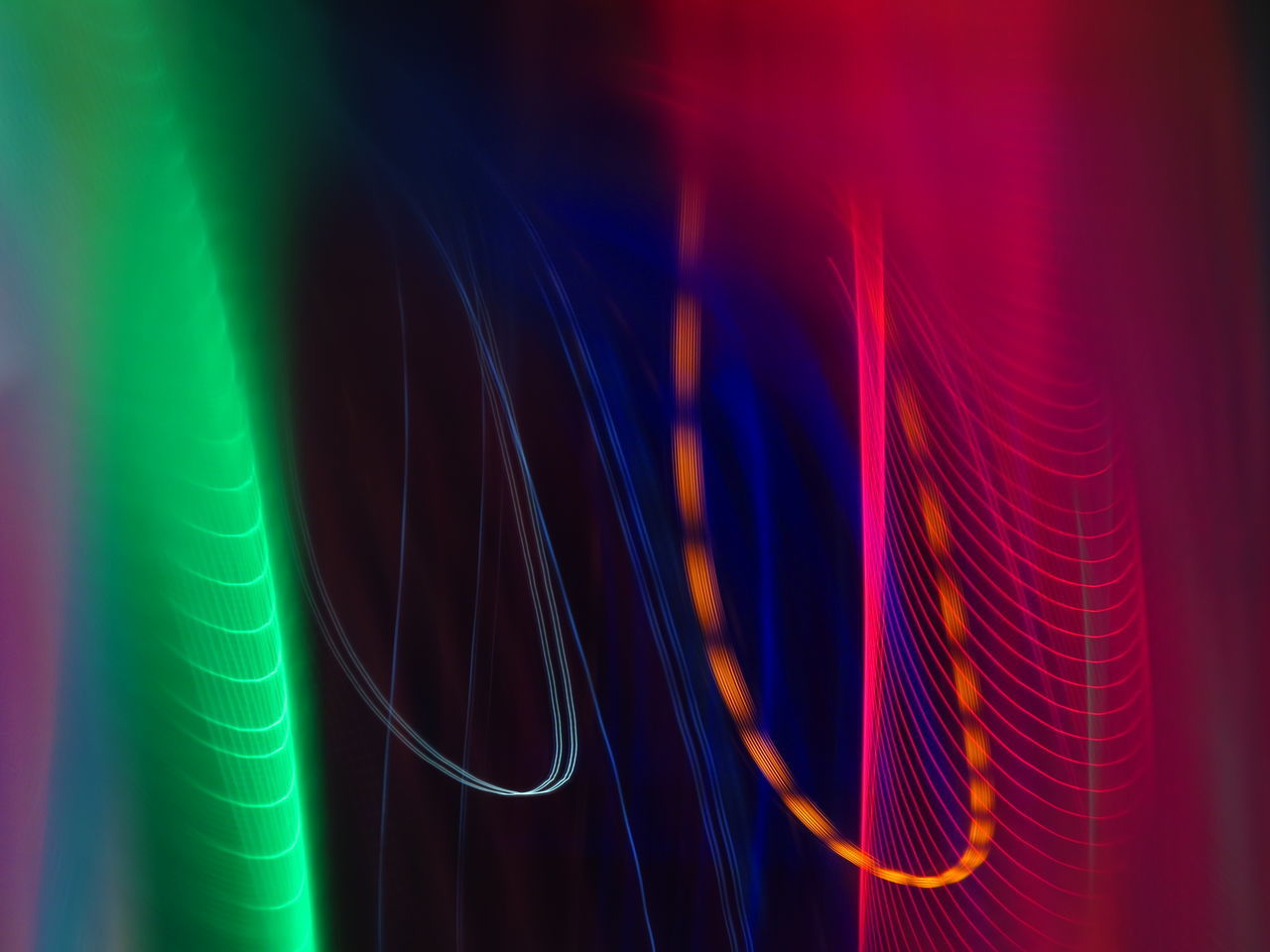 CLOSE-UP OF MULTI COLORED LIGHT TRAILS