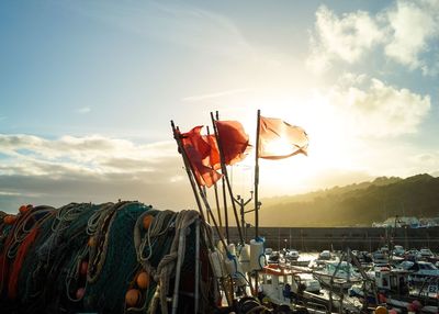 Red flags on boat against sky