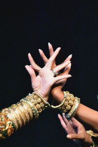 Close-up of woman hand against black background