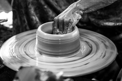 Person working on pottery wheel